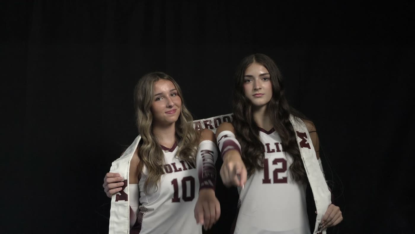 Two Moline volleyball teammates posed together in a dramatic media-day portrait